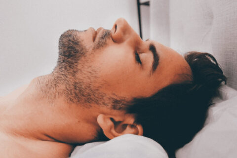 A man laying down on a pillow