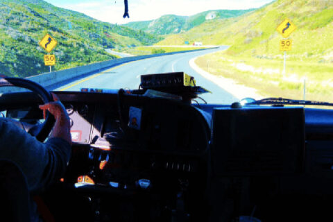 A truck driver driving down a highway