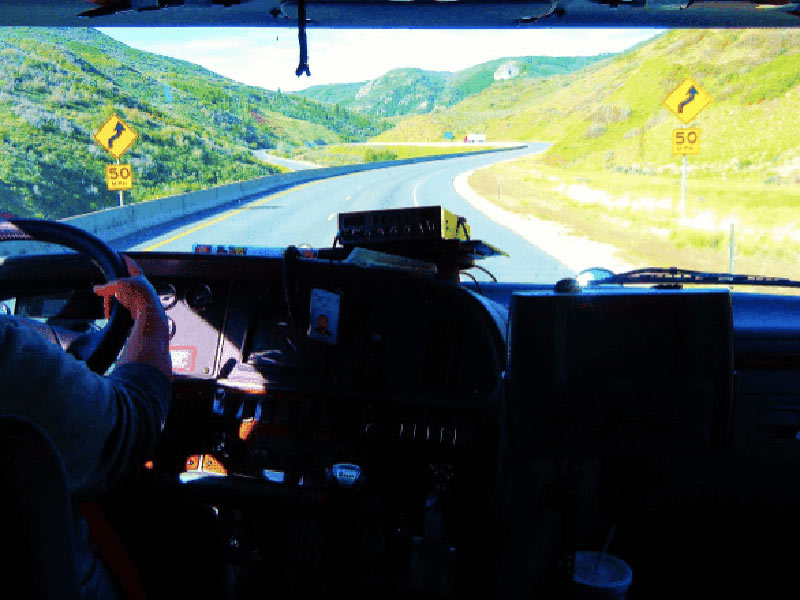 A truck driver driving down a highway